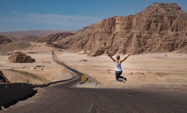 woman, jump, desert, jumping woman, road, street, badlands, barren, nature, barren landscape, freedom, happy, joy, summer, egypt, dahab, sky, landscape, mountains, rocky mountains