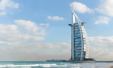 Stunning view of Burj Al Arab with a serene beach setting in Dubai, UAE.