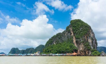 Picturesque seascape in Phang Nga Bay, Thailand featuring dramatic limestone cliffs and serene waters.