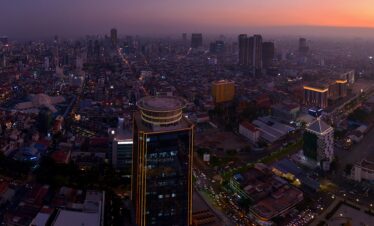 Stunning aerial view of Phnom Penh's cityscape at sunset, showcasing urban architecture.