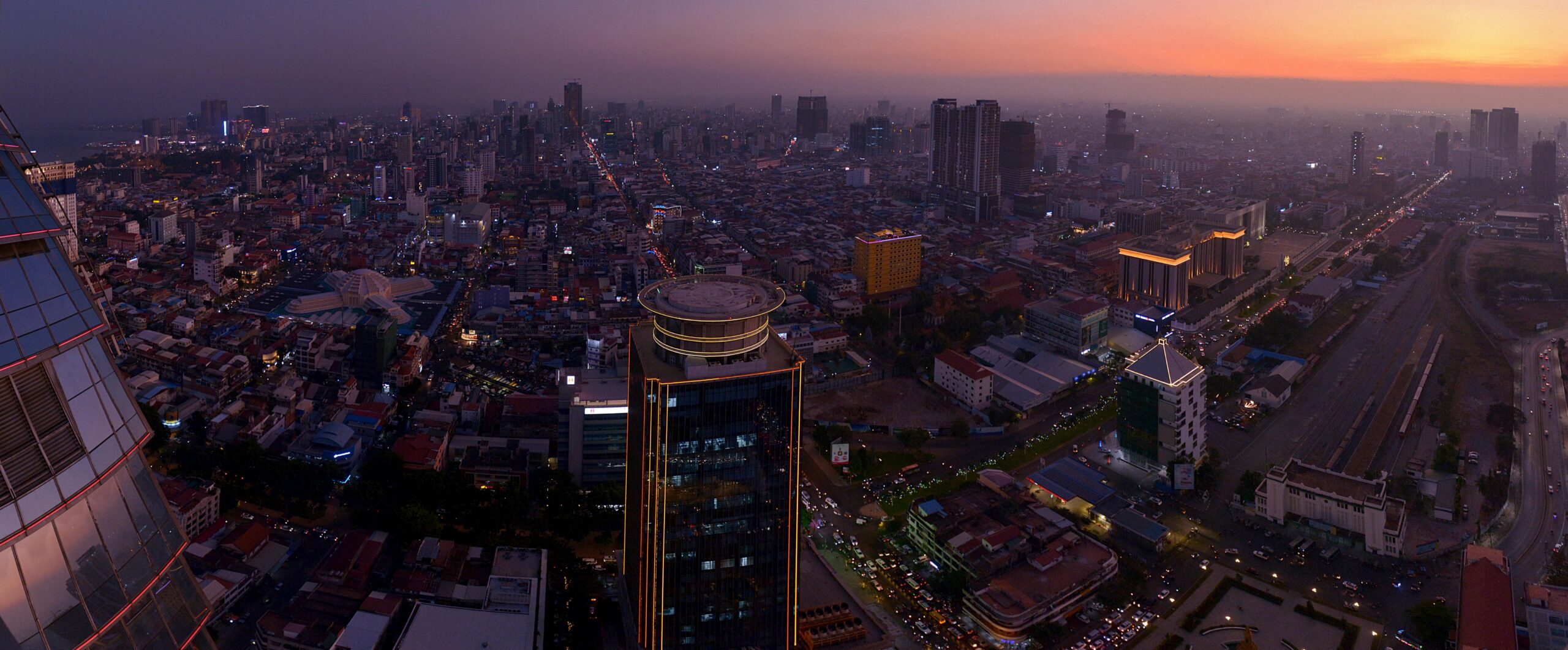 Stunning aerial view of Phnom Penh's cityscape at sunset, showcasing urban architecture.