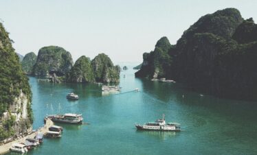 A breathtaking view of Halong Bay with boats navigating through limestone islands.